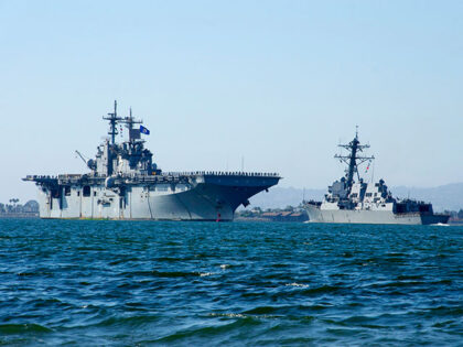 The amphibious assault ship USS Essex (LHD 2) passes the Arleigh Burke-class guided-missil