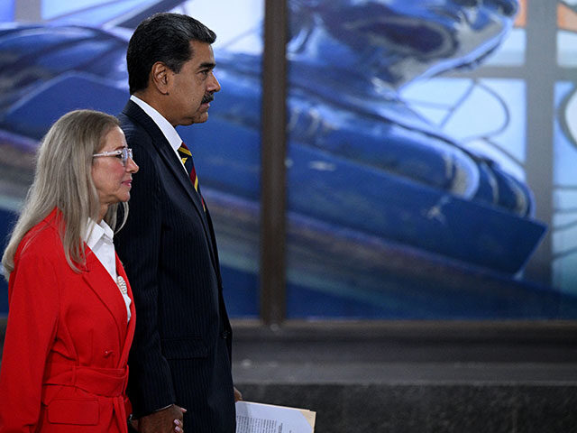 Venezuela's President Nicolas Maduro (R), accompanied by his wife Cilia Flores, leaves aft