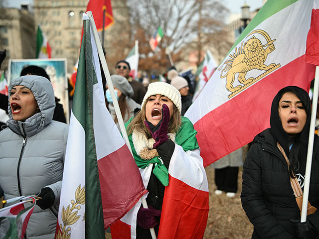 Activists take part in a rally supporting protestors in Iran at Lafayette Square, across f