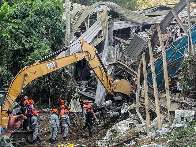 GettyImages2254740889 Search and rescue teams look for people after a landslide at the landfill in Barangay Bina