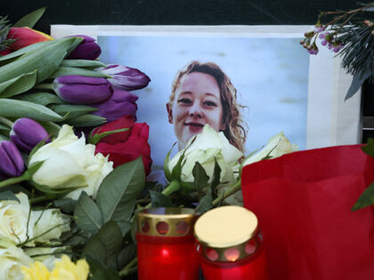 A makeshift memorial is seen as visitors attend a vigil for Renee Nicole Good in front of