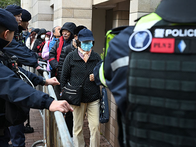 GettyImages2256914594 Visitors pass by police as they enter the West Kowloon Magistrates' court in Hong Kong on