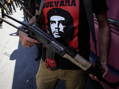 Palestinian militant of the Popular Front for the Liberation of Palestine (PFLP), holds hi