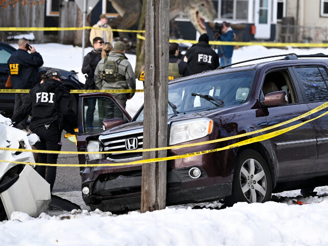 Members of law enforcement work the scene following a suspected shooting by an ICE agent d