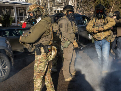 Federal law enforcement agents use irritant on demonstrators and onlookers during a raid i