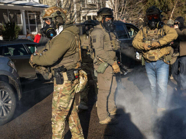 Federal law enforcement agents use irritant on demonstrators and onlookers during a raid i