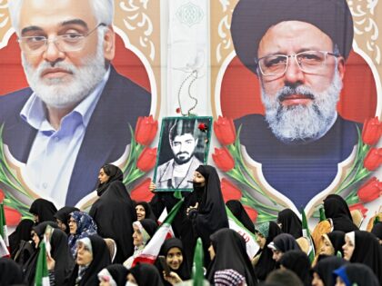 TEHRAN, IRAN - 2026/01/01: A woman holds a portrait of Qassem Soleimani as she walks past