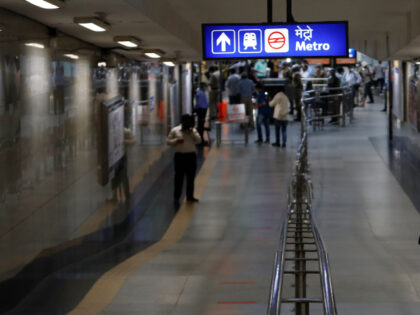 A Delhi policeman walks out from a Delhi Metro station wearing a face mask in New Delhi, I