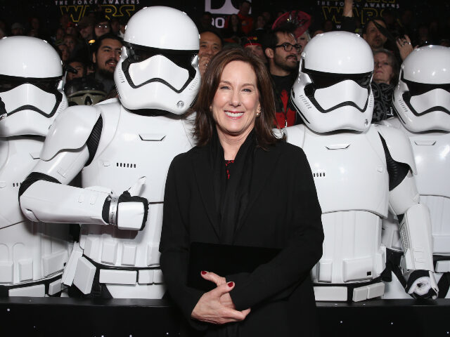 Lucasfilm President Kathleen Kennedy poses with Stormtroopers at the Premiere of Walt Disn