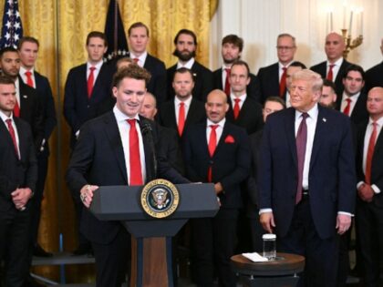 US President Donald Trump (R) listens as Matthew Tkachuk, alternate captain of NHL's