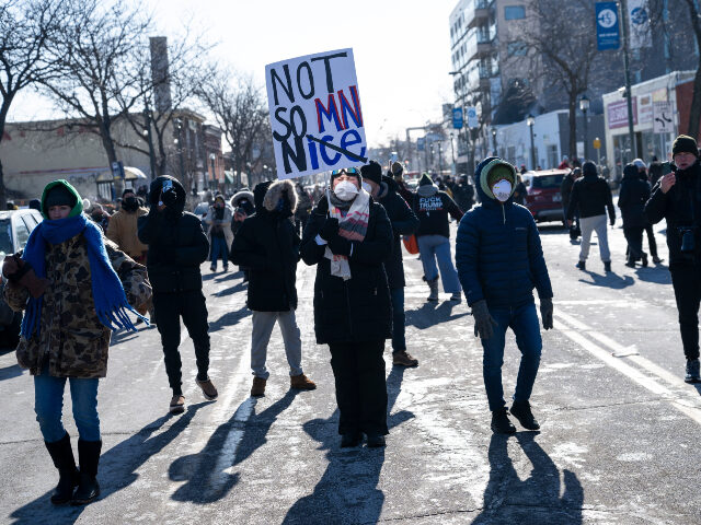 People demonstrate on Nicolett Avenue after a fatal shooting by federal agents on January
