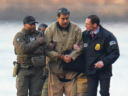 Nicolas Maduro is seen in handcuffs after landing at a Manhattan helipad, escorted by heav