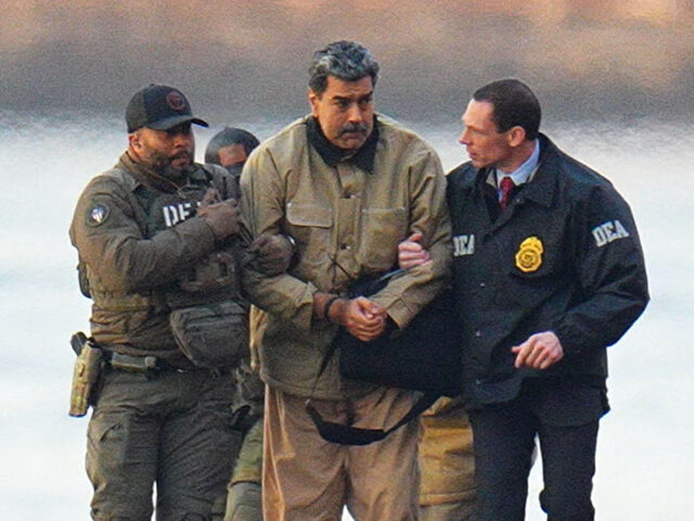 Nicolas Maduro is seen in handcuffs after landing at a Manhattan helipad, escorted by heav