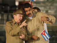 Cuban President Raul Castro speaks with Venezuela's President Nicolas Maduro during a