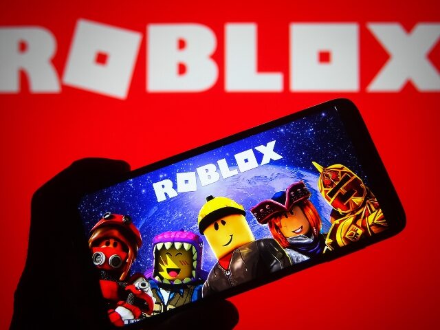 Roblox player holding phone