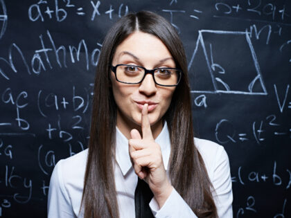 Teacher with finger to lips