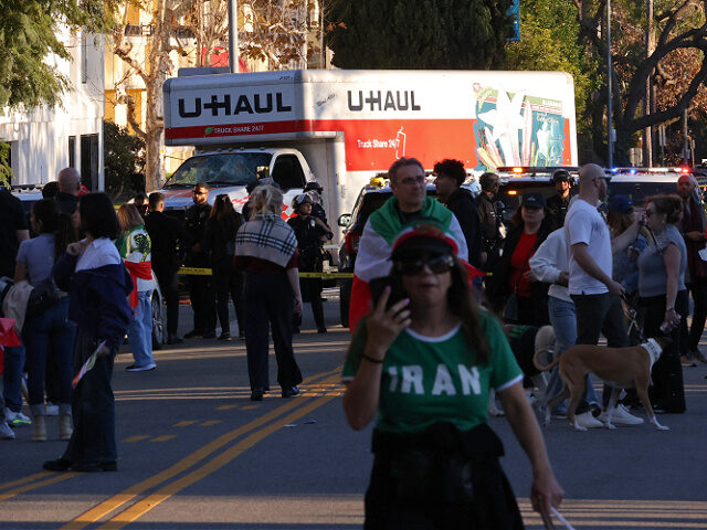 People walk near a U-Haul truck that reportedly was driven into a crowd during an anti-Ira
