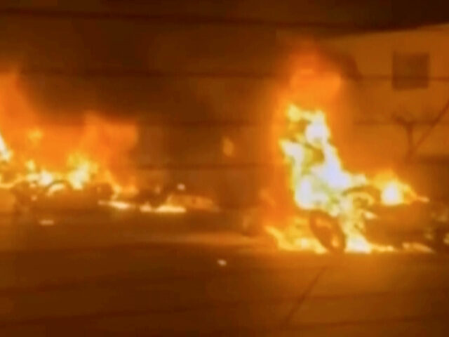 This frame grab from a video released by Iran state TV shows vehicles burning amid night o