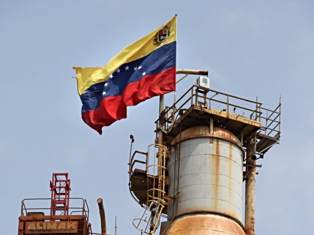 A Venezuelan flag is displayed on a oil refinery in the Venezuelan city of Moron on April