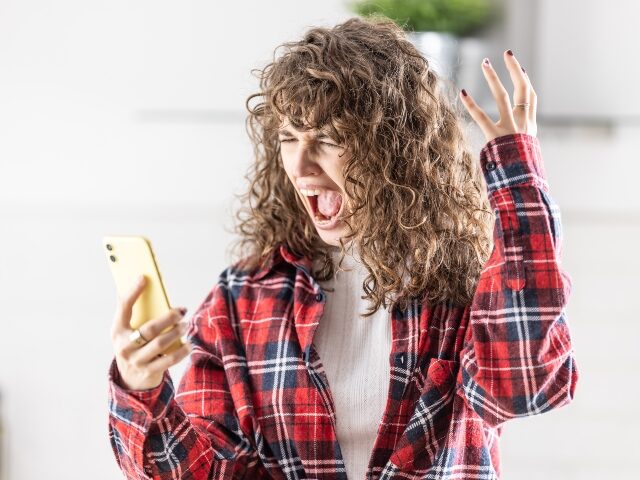 angry woman with smartphone
