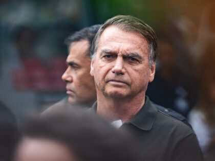 Jair Bolsonaro, Brazil's former president, center, departs from a scheduled surgery at the