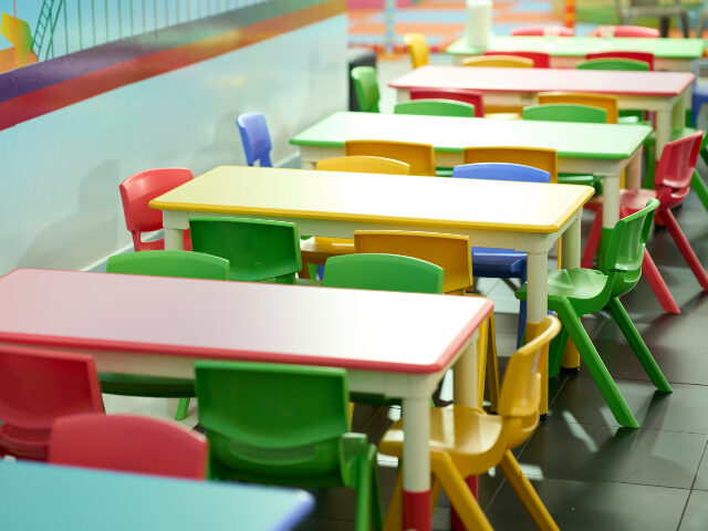 Colorful children's tables and chairs in a vibrant classroom setting.