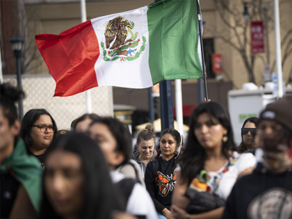 gaispc2 SAN FRANCISCO, UNITED STATES - FEBRUARY 16: A protestor flies a Mexican flag during a rall