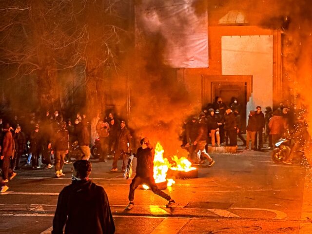 Iranians gather while blocking a street during a protest in Tehran, Iran on January 9, 202
