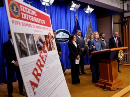 WASHINGTON, DC - DECEMBER 4: A poster reads "ARRESTED" in bold letters as Attorn