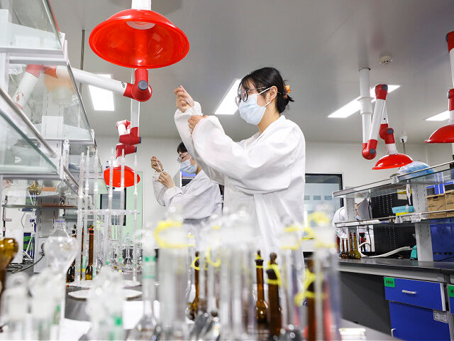 A researcher from a pharmaceutical company performs an experiment in a laboratory in Huai'