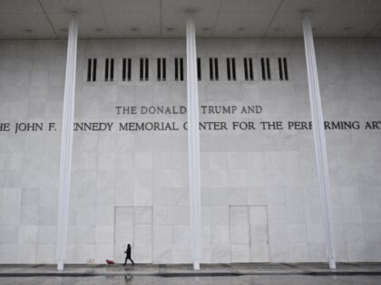 A person and a dog walk in front of the Kennedy Center in Washington, DC on January 10, 20