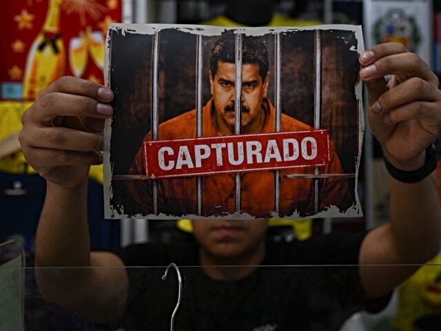 maduro capture A man shows an image featuring a digitally altered image of the ousted Venezuelan Presiden