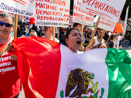 A protester waves a Mexican flag as protests continue in Los Angeles on June 10, 2025, fol