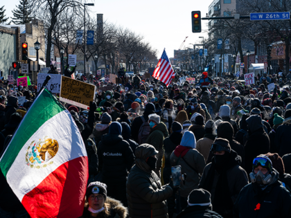 MINNEAPOLIS, MINNESOTA - JANUARY 24: People gather at the intersection of 26th Street and