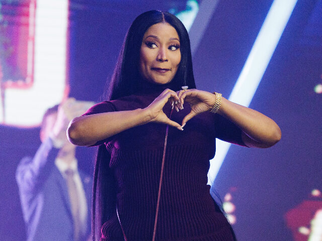 PHOENIX, ARIZONA - DECEMBER 21: Nicki Minaj enters the stage as the surprise guest on the