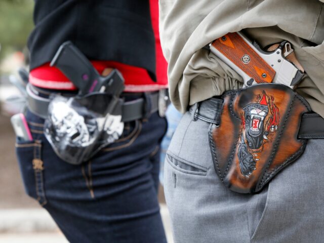 AUSTIN, TX - JANUARY 1: Art and Diana Ramirez of Austin with their pistols in custom-made