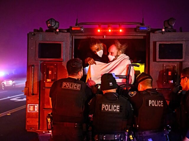 palisades fire victims Elderly patients are quickly evacuated into an armored vehicle as embers and flames approa