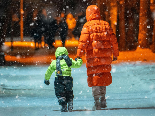 pexels-freestockpro-10688416 Woman with Kid Walking on Sidewalk on Winter Night