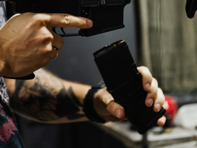 Person Reloading a Rifle