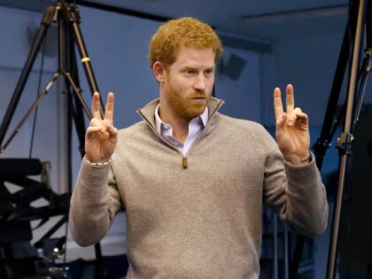 Britain's Prince Harry, right, gestures as he speaks to Matt Attwood after he demonstrated