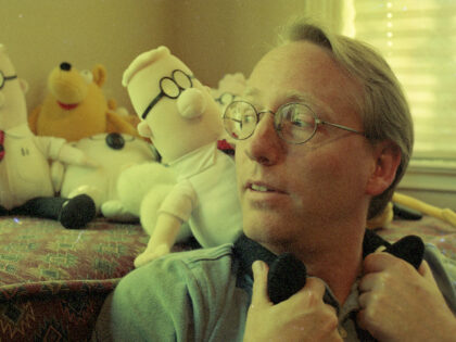 Cartoonist Scott Adams, the creator the “Dilbert” comic series, poses with Dilbert pus