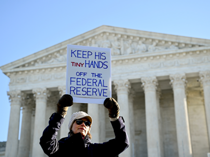 A demonstrator holds a sign supporting Fed Governor Lisa Cook outside the U.S. Supreme Cou