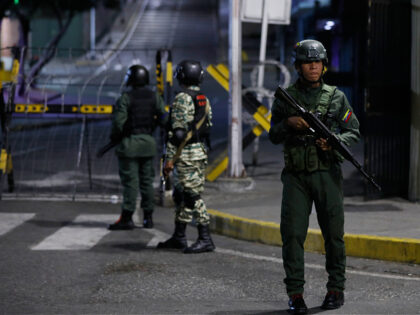 Soldiers guard the area around the Miraflores presidential palace after explosions and low