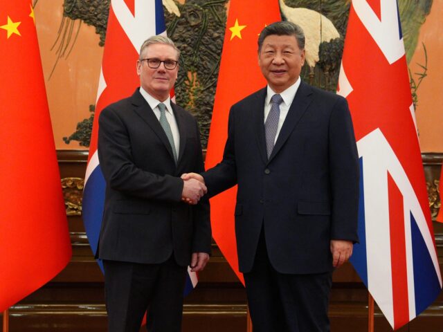 starmer and Xi China's President Xi Jinping (R) and Britain's Prime Minister Keir Starmer shake hands bef