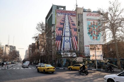 An anti-US and anti-Israel banner is displayed in Iran, which has warned against American