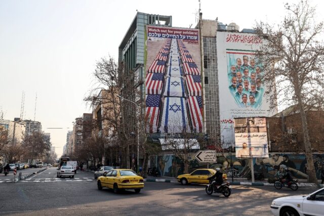 An anti-US and anti-Israel banner is displayed in Iran, which has warned against American