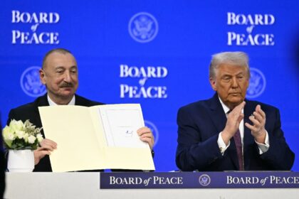 Azerbaijan's President Ilham Aliyev holds a signed founding charter of the "Boar