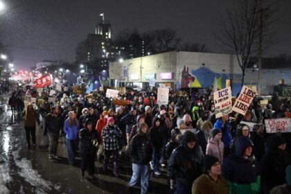People march during a protest in Minneapolis, Minnesota, after a US Immigration and Custom