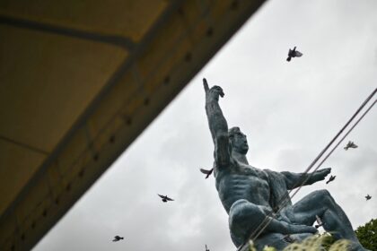Released doves fly past the "Peace Statue" in Nagasaki, part of a ceremony to ma
