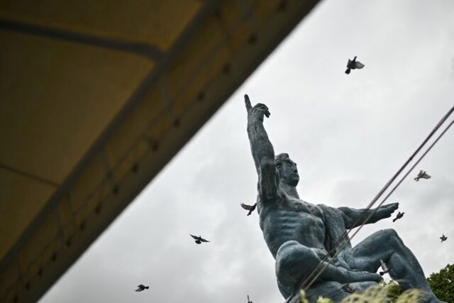Released doves fly past the "Peace Statue" in Nagasaki, part of a ceremony to ma